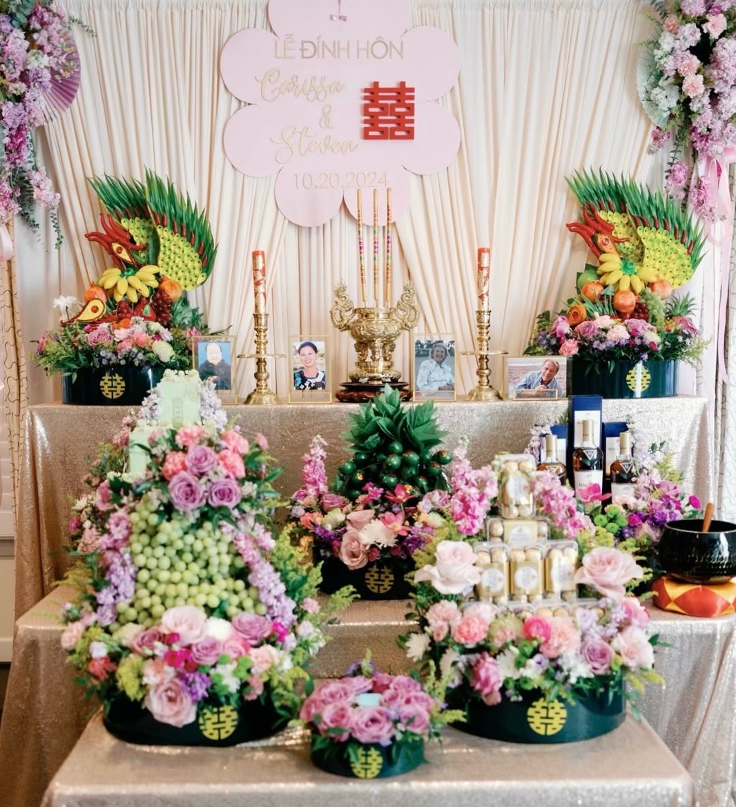 Tea ceremony altar with red and gold floral arrangements